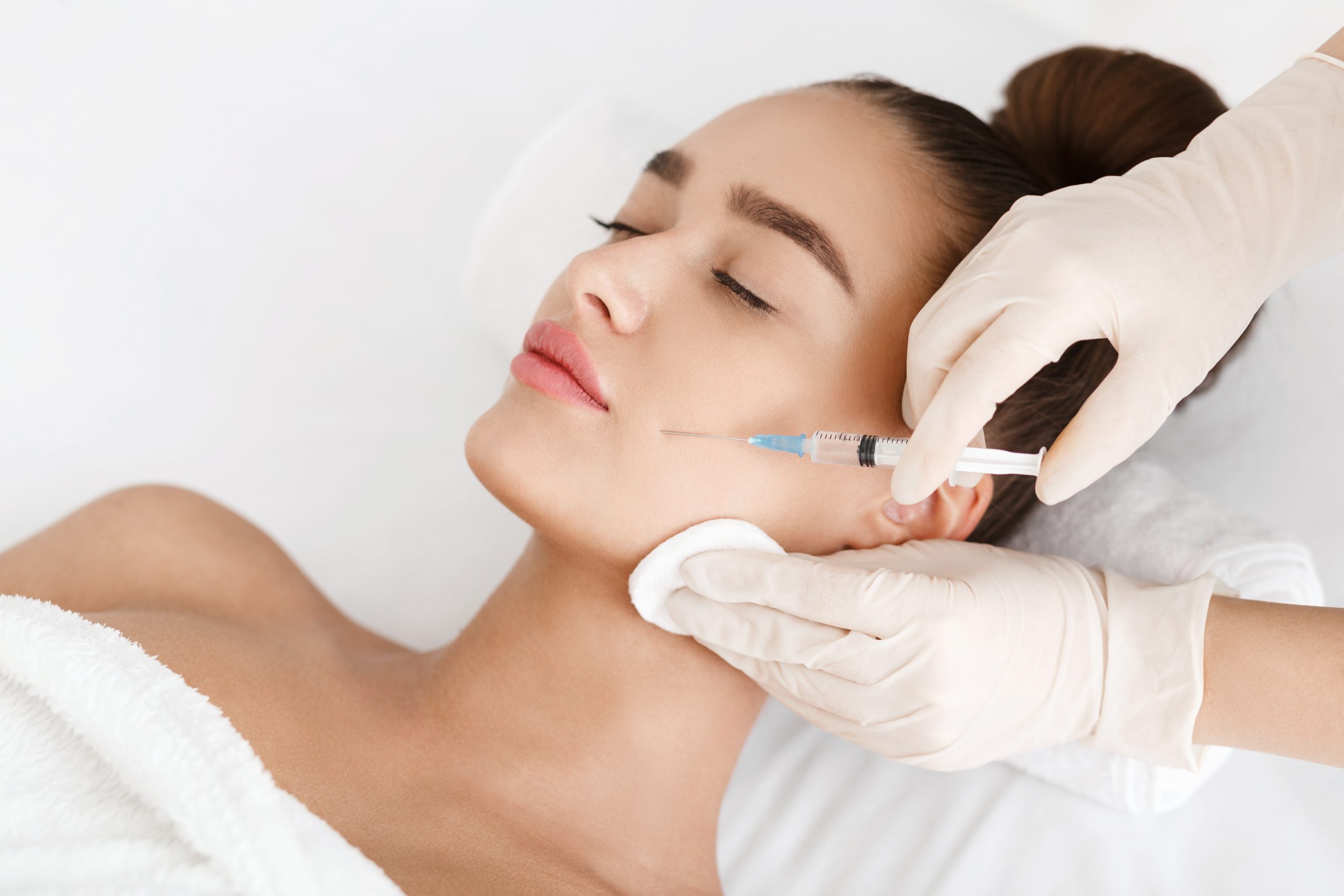Client receiving a botox injection on cheek in Wake County, NC, USA